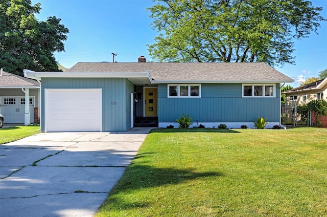 ranch-style house with a front yard and a garage