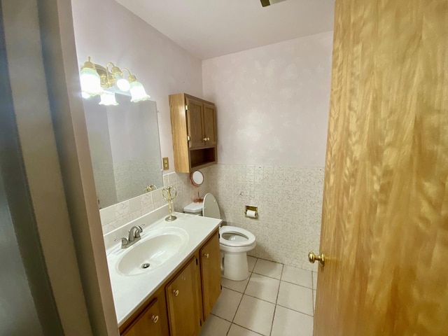 414 2nd St W, Chester, MT 59522 - bathroom featuring vanity, tile patterned flooring, toilet, wainscoting, and tile walls