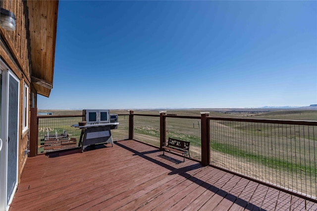 wooden terrace featuring a rural view