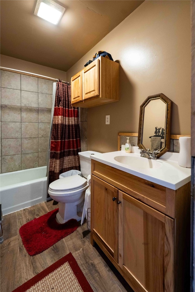 full bathroom with vanity, shower / bathtub combination with curtain, wood-type flooring, and toilet