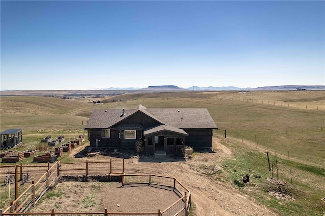 view of front of property with a mountain view and a rural view