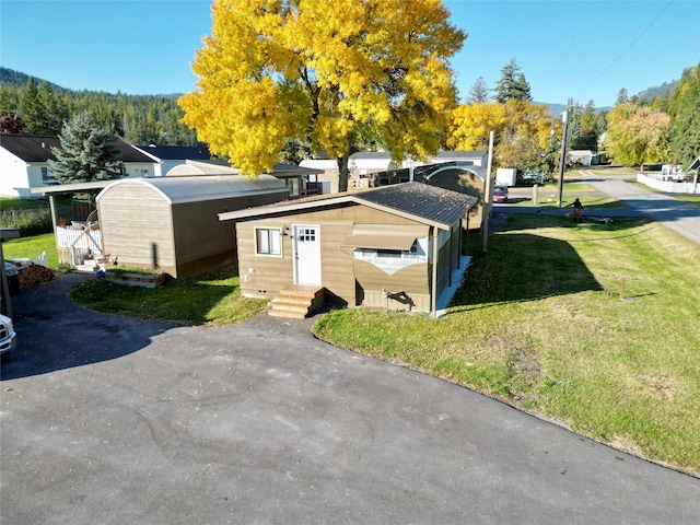 view of outbuilding with a yard