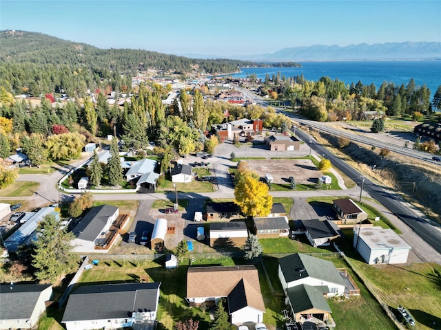 drone / aerial view featuring a water and mountain view