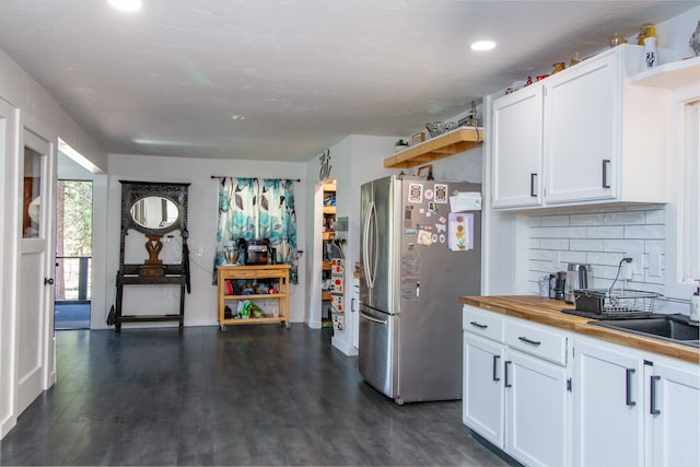 kitchen featuring stainless steel fridge, white cabinets, dark wood-type flooring, and wooden counters