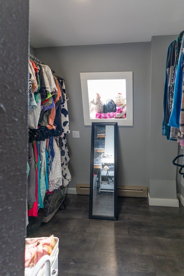 walk in closet with dark hardwood / wood-style floors