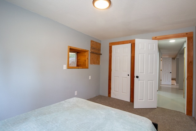 bedroom featuring a closet, carpet flooring, and a textured ceiling