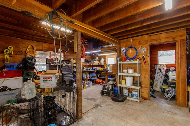 misc room with concrete floors and wooden walls