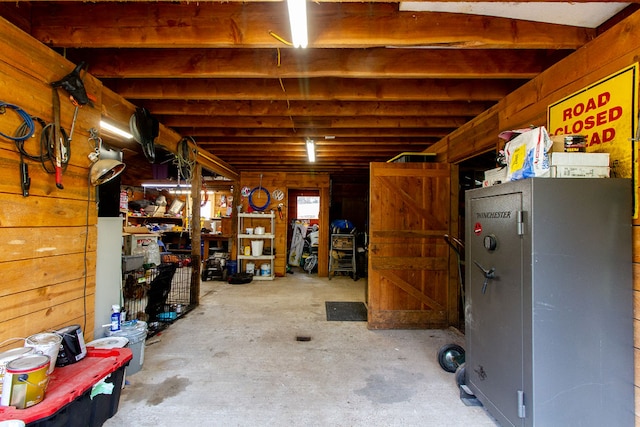 basement featuring wooden walls