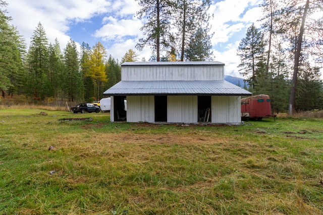 view of outdoor structure featuring a lawn