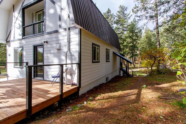 view of side of home with a deck