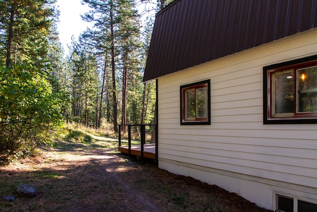 view of property exterior with a deck