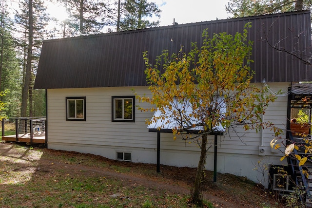 view of side of home featuring a wooden deck