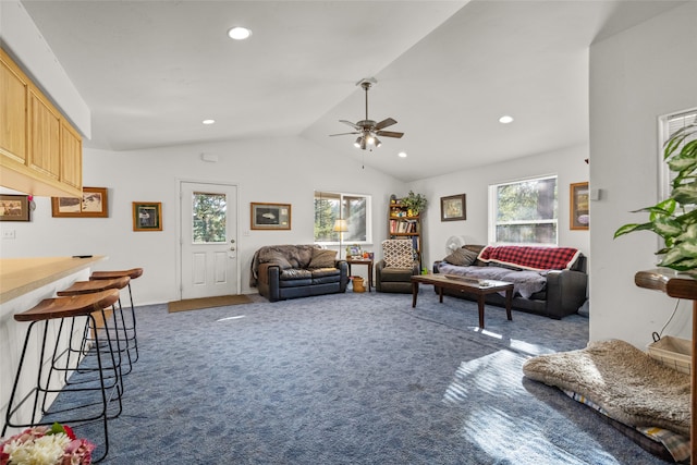 carpeted living room with ceiling fan, lofted ceiling, and a wealth of natural light