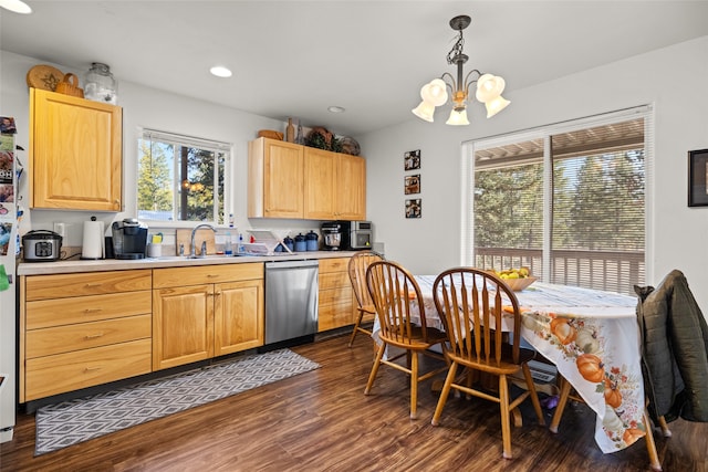 kitchen featuring light brown cabinets, hanging light fixtures, dark hardwood / wood-style flooring, stainless steel dishwasher, and sink