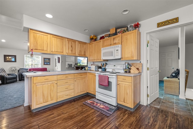 kitchen featuring light brown cabinets, kitchen peninsula, dark wood-type flooring, and white appliances