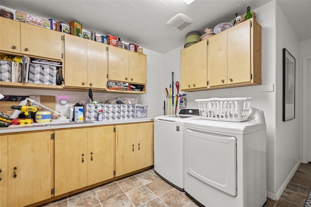 laundry room featuring independent washer and dryer and cabinets