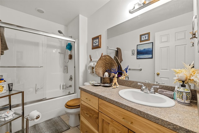 full bathroom featuring vanity, enclosed tub / shower combo, tile patterned floors, and toilet