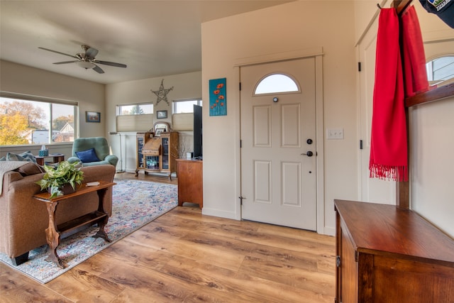 foyer featuring light wood-type flooring and ceiling fan