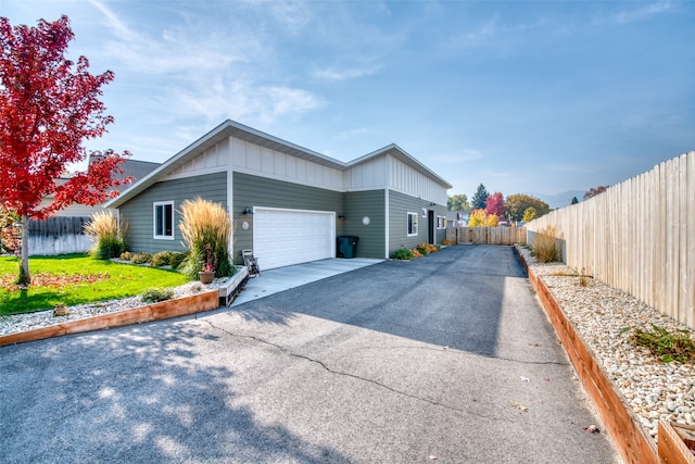 view of front of property with a front lawn and a garage