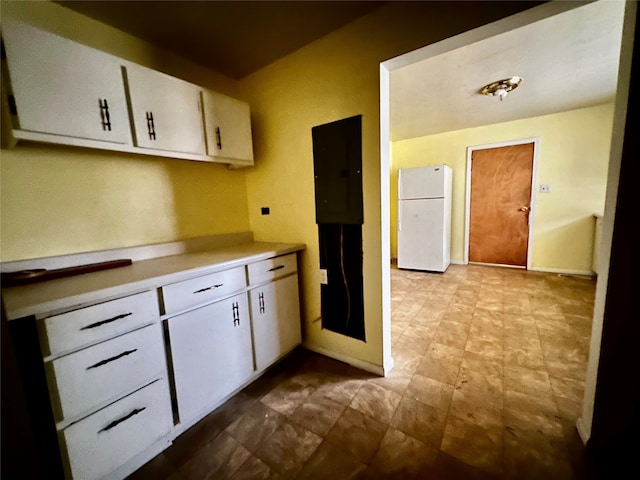 kitchen featuring white fridge and white cabinets