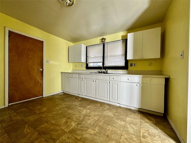 kitchen featuring white cabinetry and sink