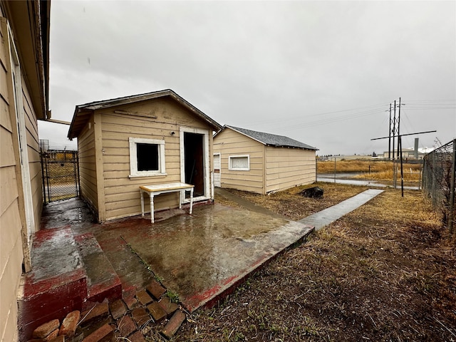 rear view of property with a storage unit