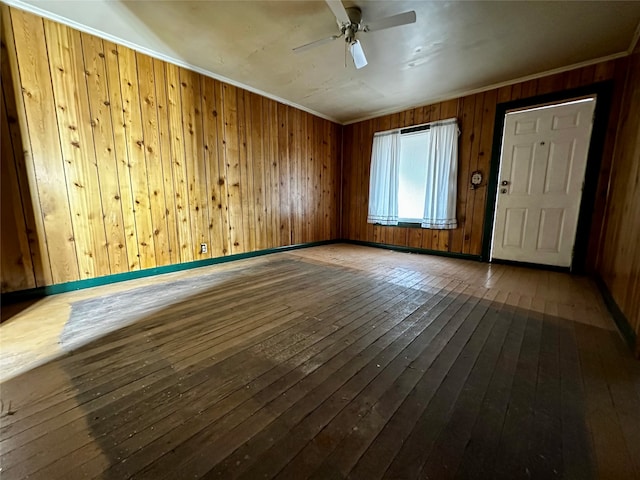 interior space featuring hardwood / wood-style flooring, wooden walls, and ceiling fan