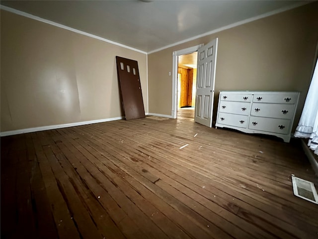 unfurnished bedroom with hardwood / wood-style flooring and ornamental molding