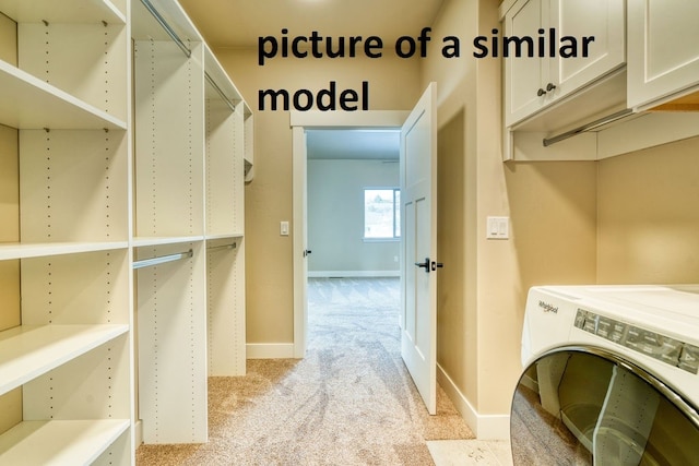 laundry area featuring washer / clothes dryer, cabinets, and light colored carpet