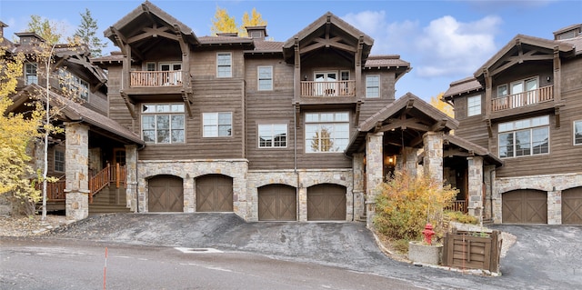 view of property with a garage and a balcony