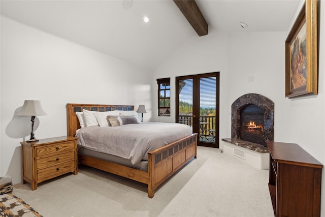 89 Slopeside Dr Unit 4, Whitefish, MT 59937 - bedroom with access to outside, beam ceiling, light carpet, a high end fireplace, and high vaulted ceiling