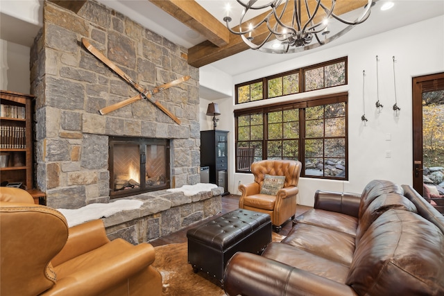 living room featuring beam ceiling, a chandelier, wood-type flooring, a fireplace, and a towering ceiling