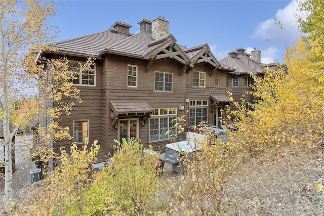 89 Slopeside Dr Unit 4, Whitefish, MT 59937 - rear view of property with a chimney and central air condition unit