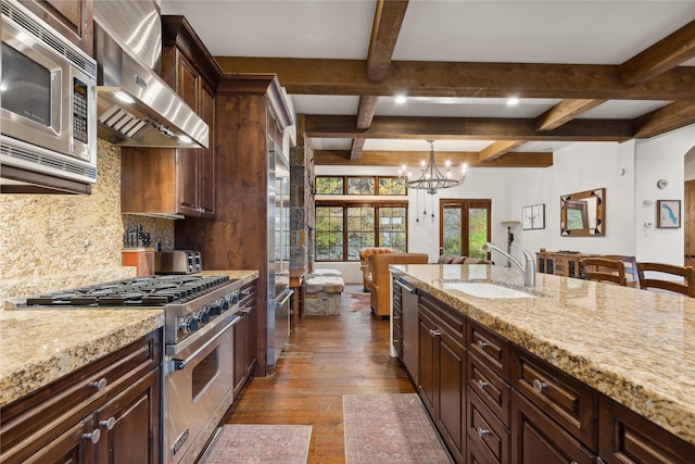89 Slopeside Dr Unit 4, Whitefish, MT 59937 - kitchen featuring high end appliances, exhaust hood, a sink, a chandelier, and coffered ceiling
