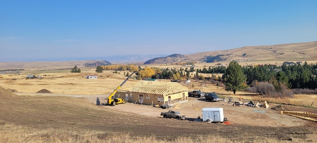 drone / aerial view featuring a rural view and a mountain view