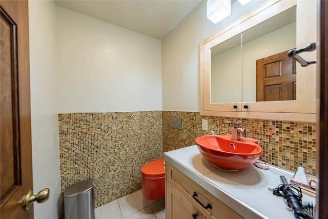 bathroom featuring tile walls, vanity, toilet, and tile patterned flooring