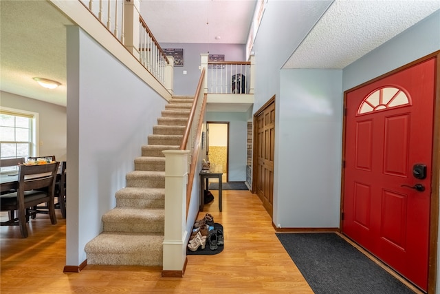 entrance foyer featuring a textured ceiling and light wood-type flooring