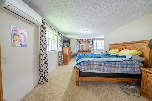 carpeted bedroom featuring a textured ceiling and a wall mounted AC