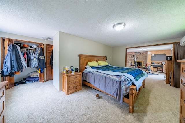 carpeted bedroom with a closet and a textured ceiling