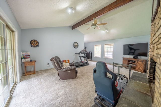 interior space with a textured ceiling, ceiling fan, carpet flooring, and vaulted ceiling