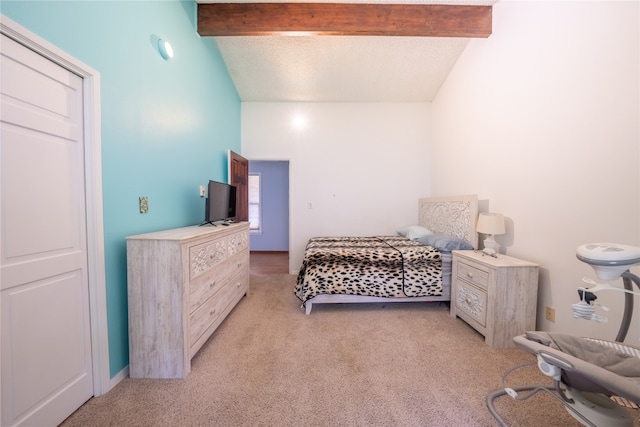 carpeted bedroom featuring lofted ceiling with beams