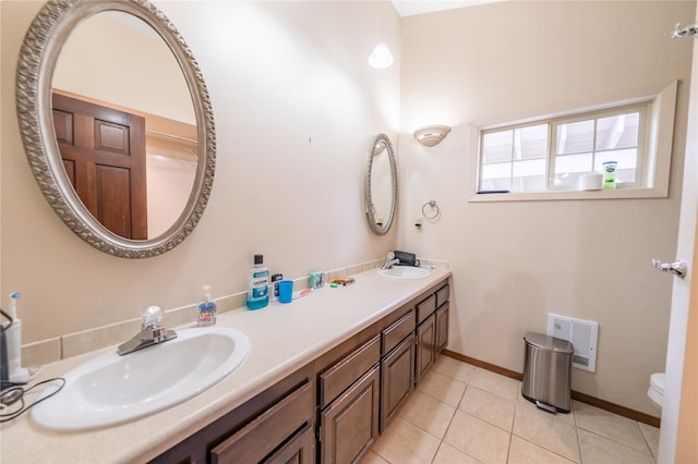 bathroom with vanity, toilet, and tile patterned floors