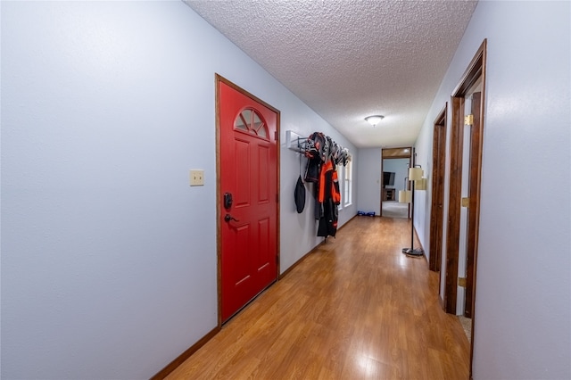 hall featuring a textured ceiling and wood-type flooring