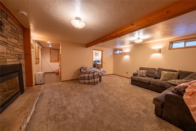 living room featuring beam ceiling, a stone fireplace, a textured ceiling, and carpet floors