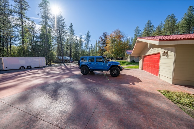 view of parking / parking lot with a garage