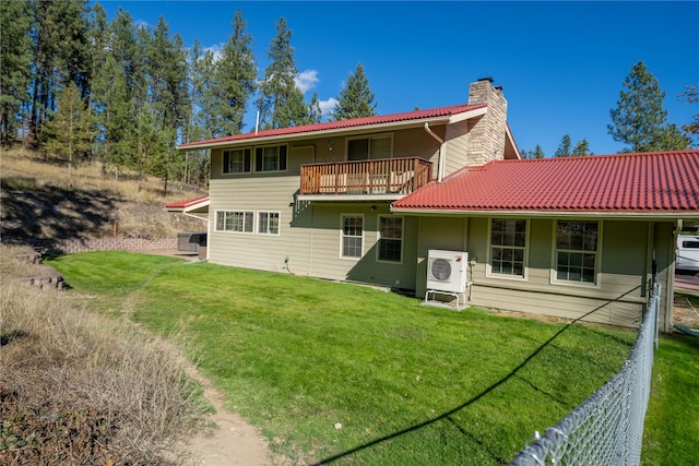 back of property with a lawn and ac unit