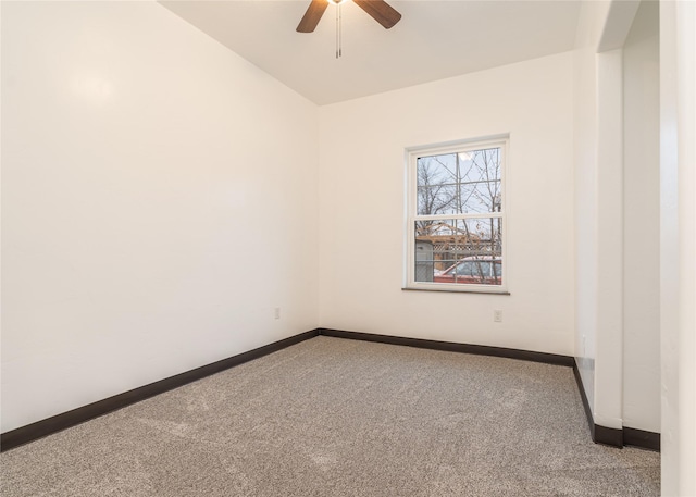 carpeted spare room featuring ceiling fan