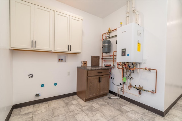 clothes washing area with cabinets, washer hookup, hookup for an electric dryer, and water heater