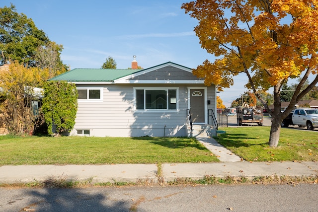 bungalow-style house featuring a front yard