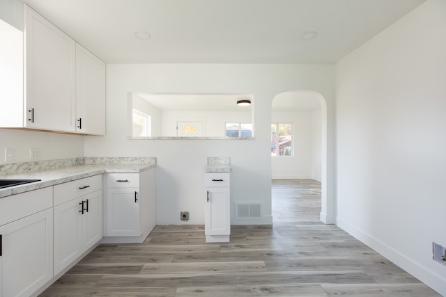 kitchen featuring light hardwood / wood-style floors and white cabinets